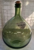 A substantial French carboy / demijohn with a shield shaped label titled 