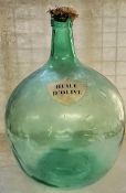 A substantial French carboy / demijohn with shield shaped label titled 