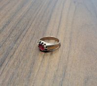 A early 20th century 9ct rose gold gypsy ring, centrally set with round round red stone, size M, 4.