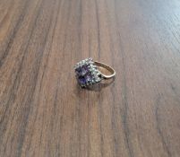 A contemporary 9ct gold cluster ring, the square setting set with four central princess cut