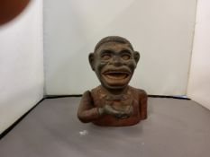 A Jolly Blackman cast iron money bank, 16.5cm high