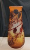 An Art Glass ovoid vase, etched with pine tree and cones, in red on a mottled yellow ground, bears