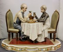 A Capo-di-Monte figure group, modelled by Sandra Maggious, signed, Anniversarie, 32cm wide,