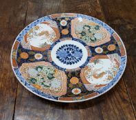 A Japanese Imari charger, the centre with floral roundel, the sides with four reserves alternating