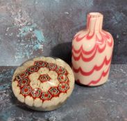 An English domed glass millieflori paperweight, alternating floral stems in red and white, 8cm diam;