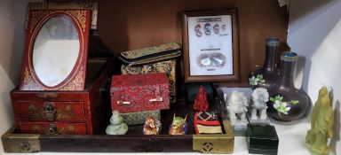 A cinnabar lacquer dressing table casket jewellery box, the hinged gilt decorated cover revealing