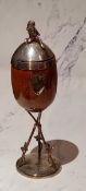 A Victorian E.P.N.S. and oak cup on stand, with cherub finial, 28cm high, c.1890