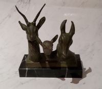 Art Deco, a green patinated bronze, deer family group, heads, rectangular marble base, 19cm high