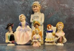 A German half doll;  others;  a German bisque figure, of a lady holding a spoon, c.1900;  a Royal