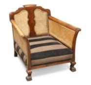 A WALNUT AND CANEWORK BERGÈRE CHAIR, CIRCA 1920-30