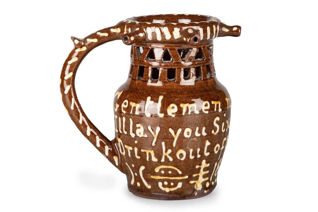 A NORTH COUNTRY SLIPWARE PUZZLE JUG