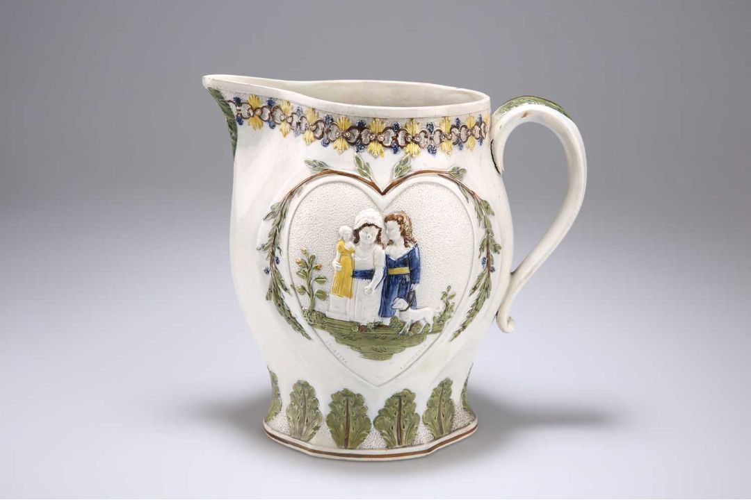 A PEARLWARE JUG MOULDED WITH SCENES REPRESENTING 'MISCHIEVOUS SPORT' AND 'SPORTING INNOCENCE' - Image 1 of 3