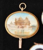 Pocket watch key with 14 ct. gold cross oval setting, Indian temple,