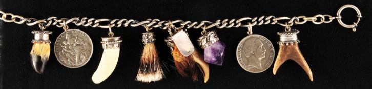 Charivari silver necklace with various pendants in ornate settings, 