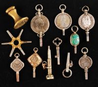 Convolute of 11 pocket watch keys and 1 petal, silver and gold plated,