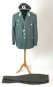 A reproduction or re-enactors copy of a German WW2 Police uniform, comprising tunic and trousers,