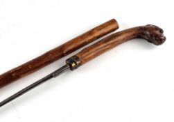 Victorian sword cane with a handle carved as a dog with red glass eyes