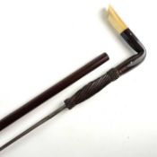 A late 19th/early 20th-century sword cane, with an angular horn handle and ferrule/heel, opening
