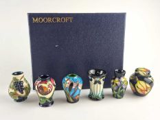A set of six Moorcroft miniature vases, in fitted case.