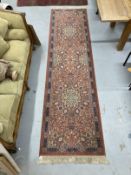 Carpets & Rugs: 20th cent. Keshan runner, red ground with stylised floral decoration and one
