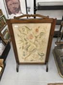 Early 20th cent. Mahogany fire screen with panel of crewel work embroidery. 29ins. x 23ins.