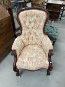 19th cent. Button back upholstered library armchair, carved scroll arms and cabriole legs. 27ins.
