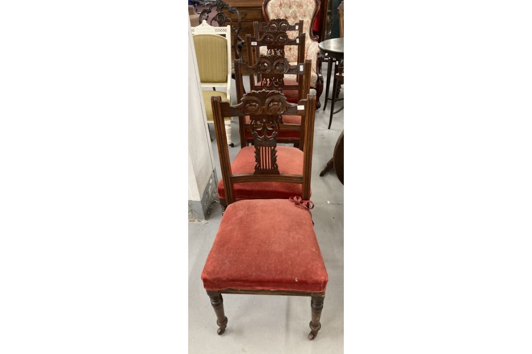 Edwardian mahogany dining chairs with carved backs and turned front supports terminating in castors. - Image 1 of 3