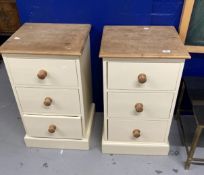 20th cent. Painted pine bedside cupboards, each with three drawers, knob handles on plinth bases,