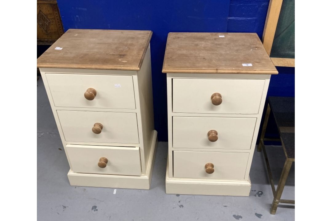 20th cent. Painted pine bedside cupboards, each with three drawers, knob handles on plinth bases,