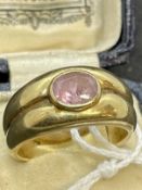 Jewellery: Yellow metal ring tapering band, width 10mm tapering to 5mm, set with an oval cut pale