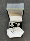 Jewellery: White metal pair of stud earrings set with a single 7.5mm cultured pearl and a