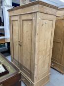 20th cent. Stripped pine Continental cupboard converted to wardrobe having two doors over two