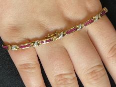 Jewellery: Yellow metal bracelet set with forty-four calibre set rubies, estimated weight of (44)