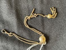 Jewellery: Yellow metal watch Albert swivel at one end and a tassel at the other end. Total weight