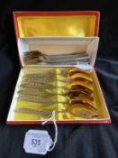 Russian Silver: White metal set of six teaspoons with scroll pattern handle and gilt bowls, test