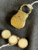 Jewellery: Yellow metal locket in the form of a purse, tests as 18ct gold. Weight 5.3g. Plus three