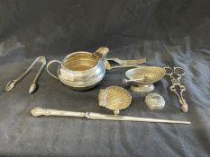 Hallmarked Silver: Cream jug, shell condiment, fork, sugar spoon, paper knife with steel blade,