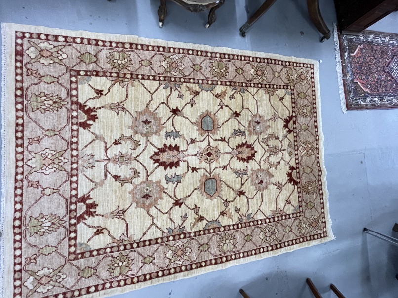 Rugs & Carpets: Modern weave rug, ivory colour highlighted with reds, blues and green. 81ins. x