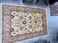 Rugs & Carpets: Modern weave rug, ivory colour highlighted with reds, blues and green. 81ins. x