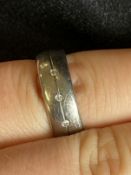 Jewellery: Gentleman's three stone diamond titanium wedding band, size Q. 4.2g.