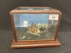Diorama of a ship at sea with a lighthouse in the background. A/F
