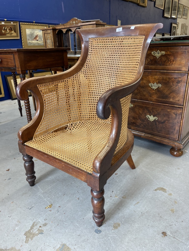 19th cent. Mahogany library chair with bergere back and seat, the latter requires attention.