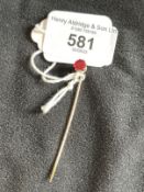 Jewellery: Yellow metal stock pin set with a single red tourmaline, estimated weight 1.25ct, tests