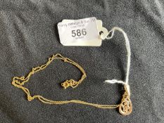 Jewellery: Yellow metal trace link chain with a pear drop pendant attached set with an amethyst