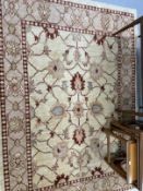 Rugs & Carpets: Modern weave rug, ivory colour highlighted with reds, blues and green. 81ins. x