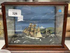 Diorama of a ship at sea with a lighthouse in the background. A/F