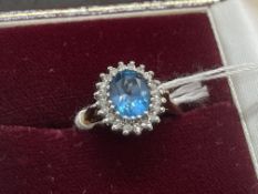 Jewellery: 9ct gold ring central set with an oval cut blue topaz, estimated weight 2.25ct,