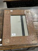 Beaten copper mirror in the style of Liberty's. 13ins. x 12ins.