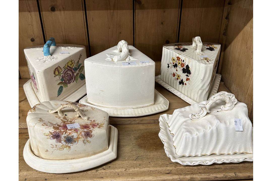 Staffordshire, five large cheese dishes all with floral decoration from various makers.