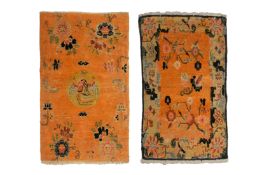 TWO TIBETAN ORANGE GROUND SMALL WOOL RUGS
